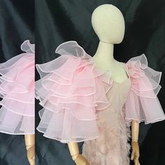 two mannequins wearing pink dresses with ruffles