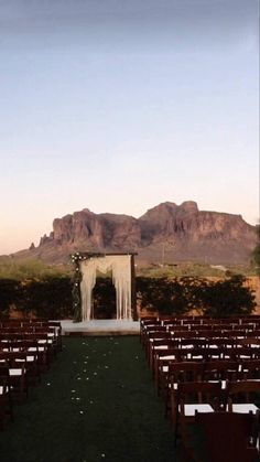 an outdoor ceremony set up in front of mountains