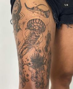 a woman's thigh with tattoos on it