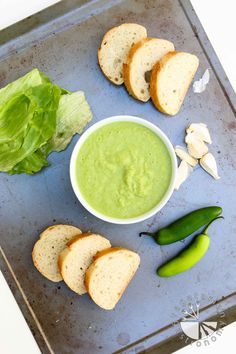 a tray with bread, lettuce and other foods on it