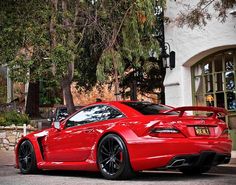 a red sports car parked in front of a building