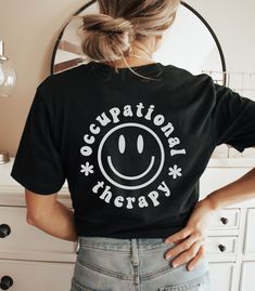 This Occupational Therapy Shirt / Occupational Therapist Shirt is perfect for the OT! Cute and soft - the OT in your life will love it! ~  **FRONT & BACK PRINT**  **UNISEX SIZING**  Click here to return to our shop's home page ⇒ https://www.etsy.com/shop/SketchyCatDesigns ♥ W E L C O M E  T O  S K E T C H Y  C A T  D E S I G N S ! ♥ All of our products are printed with eco-friendly water-based inks, giving them the softest feel. The design itself is embedded into the fabric so that your shirt is Med Surg Nurse, Occupational Therapy Gifts, New Grad Nurse, Med Surg Nursing, Occupational Therapy Shirts, Surgical Nursing, Medical Surgical Nursing, Therapy Gift, Med Surg