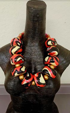 I just love the colors on this OOAK Artisan Statement Necklace - Bib Chest Piece! Each black, red and cream hand sculpted rondelle measures approximately 2" and is separated from each other by a large gold metallic wood bead. This is a non-adjustable 27" in length and closes with a thin bronze hook. The back is finished with various red and gold wood beads, red beads and a gold tone tribal spacer. The beads on this piece are lightweight. Each was hand sculpted by me, painted and then sealed with Rocker Chic Accessories, Unique Pendant Necklace, Statement Bib Necklace, Chest Piece, Mermaid Necklace, Beaded Statement Necklace, African Jewelry, Statement Pendant, Rope Necklace