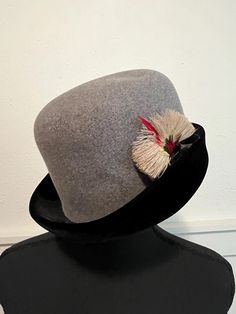 Lovely women's mid-century wool hat. Gray with black brim. Lovely feather accent on the side brim. Made in Italy. Excellent condition Interior circumference is 21 inches Winter Fedora With Feather Trim, Winter Fedora Hat With Feather Trim, Formal Cloche Mini Hats For Winter, Formal Winter Cloche Mini Hat, Flat Brim Top Hat For Winter Evenings, Flat Brim Top Hat For Evening In Winter, Kentucky Derby Fur Felt Cloche Hat With Flat Brim, Vintage Fur Felt Hat For Fall, Fur Felt Cloche Hat With Flat Brim For Winter