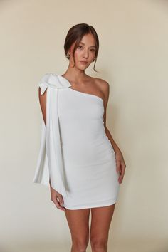 Mischa One Shoulder Bow Bodycon Mini Dress White Dress With Red Accessories, One Shoulder White Dress Short, Graduation Dresses Winter, Hoco Dresses With Bow, Short Grad Dress, White Halter Dress Short, White Hoco Dress, White Dress With Bow, White Semi Formal Dress