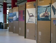 several cardboard boxes with pictures on them are lined up against the wall in an office building