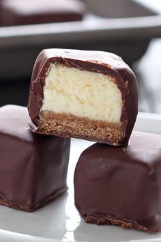 three pieces of chocolate on a white plate