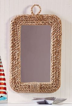 a mirror hanging on the side of a wall next to an american flag hat and other items