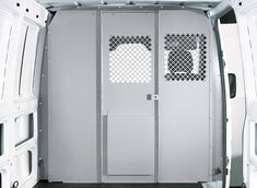 the inside of a white van with its doors open and windows closed to let in light