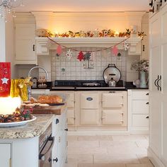 a kitchen decorated for christmas with candles and decorations