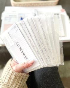 a person holding up a stack of papers in their hand with the word crochet written on them