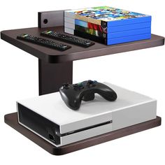 a computer desk with a video game console and remote