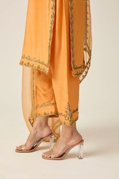 RUQSAT Kurta Set. Made from luxurious chanderi silk, this outfit radiates sophistication and grace. The length of the kurta can be tailored to your personal preference. Comes with 3 pieces. Material: Chanderi silk and organza dupatta fabric. Organic Dying, Hand-Embroidery, Textile Manipulation in Amber Yellow color. Sizing: Once your order is placed, we will send you an email or WhatsApp regarding all the measurements that are required for your custom-made outfit for the best fit. Delivery: This Indian Formals, Simple Suits, Bridal Crop Top, Kaftan Kurta, Silk Churidar, Kurta Lehenga, Prince Coat, Aari Design, Georgette Anarkali