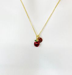 "This is a gold -tone red apple fruit charm with hand stamped initial charm on brass/stainless steel 18 inches chain. ♥ You will receive 1 necklace. HOW TO ORDER 1) Select the quantity 2) Select the initial  3) Add to cart DESCRIPTION ♥ Necklace, Gold Plated over Stainless steel Cable Chain with Lobster Claw Clasp, Size: about 17.7 inches (45cm) long, 1-2mm wide, Nickel Safe, ♥ Initial Charms, Gold Plated over Stainless steel, Size: about 8-10mm in diameter, 1mm thick, Nickel Safe, ♥ Red Apple Charm, Brass Enamel Charms, Long-Lasting Plated, Real 18K Gold Plated, Size: about 0.43 inch(11mm) wide, 0.47 inch(12mm) long, 0.38 inch(9.6mm) thick PLEASE READ: *Materials and style may be different from the list depend on stock and style of the jewelry* Due to the shipping supply and the fee being Red Charm Necklaces With Round Pendant For Gifts, Red Charm Necklace With Round Pendant For Gift, Red Nickel-free Charm Necklace For Gift, Personalized Red Round Pendant Charm Necklaces, Fruit Necklace, Apple Fruit, Stainless Steel Cable, Enamel Charms, Red Apple