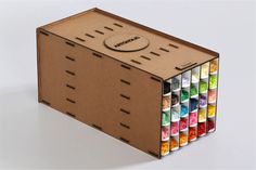 a wooden box filled with lots of different colored crayons on top of it