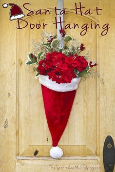 a santa hat door hanger with flowers in it