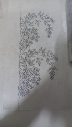 a piece of paper that has been drawn on with some type of ink and is sitting on the floor