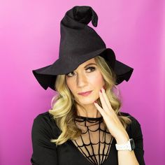 a woman wearing a black hat with a spider web on it