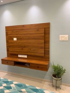 a bed with a wooden headboard and shelf on the wall next to a potted plant