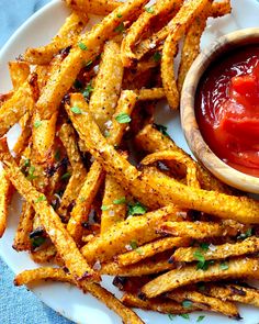 french fries on a plate with ketchup and relish in a small bowl