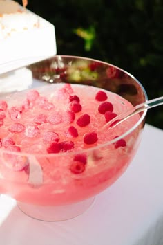 three glasses filled with pink liquid and ice