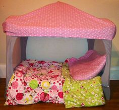 the bed is made out of fabric and has a pink canopy over it's head