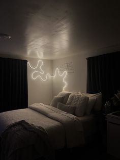 a bed in a room with lights on the wall