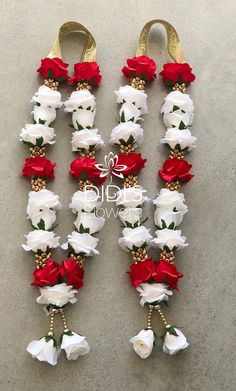 white and red flowers are arranged in the shape of letters