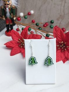 Christmas earrings designed with green lampwork beads and silver plated accent beads.   Silver plated decorative chain and silver plated ear wires - sterling silver wires available for an additional charge, please message me.  Handmade glass beads, but due to the nature that each one is hand crafted there may be slight differences in size and appearance. Holiday Green Handmade Beaded Earrings, Festive Green Dangling Beads Earrings, Green Christmas Holiday Jewelry, Handmade Green Beaded Christmas Earrings, Festive Green Dangling Beads, Xmas Earrings, Lampwork Bead Earrings, Handmade Glass Beads, Green Christmas Tree