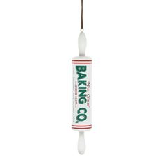 a tube of baking oil hanging from a hook on a white background with the words baking co in it