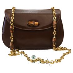 This vintage GUCCI bamboo chain shoulder bag is crafted of smooth calfskin leather in brown featuring a sturdy gold toned chain with bamboo internodes. Front flap bamboo turnlock closure opens to a new beige interior featuring a zippered pocket. Made in Italy. Measures approximately 8.75 x 6 x 3 inches Chain drop 18 inches. Comes with dustbag. Condition: Generally in good vintage condition with minor signs of wear Outside: Minor scratches on leather exterior Inside: Interior fully re-lined and f Gucci Chain Bag, Gucci Bamboo Bag, Structured Shoulder, Beige Interior, Chanel Flap Bag, Bamboo Bag, Gucci Outfits, Gucci Bamboo, Gucci Shoulder Bag