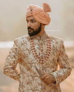 a man wearing a turban and holding a knife