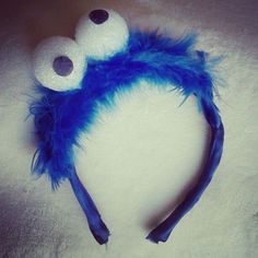 there is a blue and white headband with two eyes