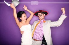 a man and woman dressed in mexican attire posing for a photo with their arms up