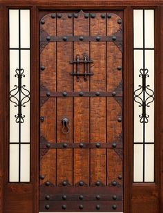 an old wooden door with wrought iron bars