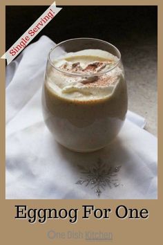 an eggnog for one is in a glass on top of a white cloth