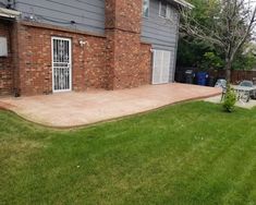 a backyard with grass and brick walls