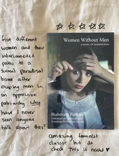 a book with writing on it next to a piece of paper that says women without men