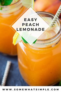 two mason jars filled with orange lemonade and garnished with minty straws