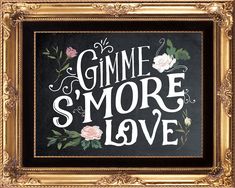 the words gimme s'more love are painted on a chalkboard in a gold frame