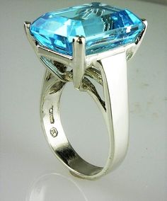 ALL OUR JEWELRY IS MADE IN THE U.S.A. Clear, blue skies on the sunniest of days THIS is the blue of this wonderful Blue Topaz, set in a wide band solitaire design. this a large Topaz but not too large, this ring is for the PRINCESS in you... or your daughter, or your wife, or mom. Whomever is the lucky girl, she will LOVE, LOVE, LOVE this ring, and so will everyone who sees her wearing it! Setting is made of solid .925 sterling silver. BEAUTIFUL Blue Topaz, (1) 16X12 Emerald cut, 12.19 Carats Formal Sterling Silver Topaz Ring With Prong Setting, Turquoise Topaz Ring In Sterling Silver For Anniversary, Turquoise Topaz Ring For Formal Occasions, Formal Aquamarine Solitaire Jewelry, Modern Blue Gemstones For Anniversary, Formal Sapphire Blue Topaz Ring In Sterling Silver, Formal Turquoise Topaz Gemstone Ring, Formal Silver Blue Topaz Ring, Hallmarked Emerald Cut Topaz Ring In Sterling Silver