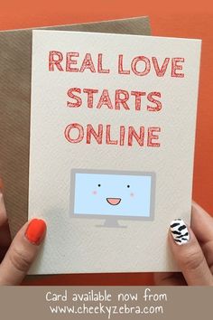 someone holding up a card with the words real love starts online on it and an orange nail polish