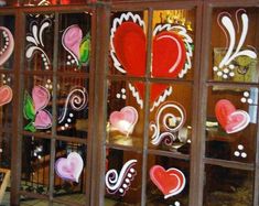 the window is decorated with hearts and swirls