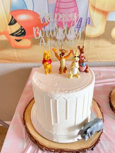 a winnie the pooh birthday cake on a table