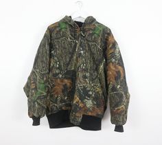 Vintage real tree camo parka lined jacket Made by wolf mountain huntingwear Size Large listed Across chest: 27 inches Length: 28 inches Sleeve: 19 inches Cotton shell, good condition! cai08 Camouflage Outerwear For Outdoor Work In Fall, Camouflage Winter Outerwear For Outdoor Work, Camouflage Utility Jacket For Winter Outdoors, Fall Camouflage Outerwear For Hiking, Camouflage Utility Jacket For Hunting In Fall, Camouflage Utility Jacket For Fall Hunting, Fall Camouflage Utility Jacket For Hunting, Real Tree Camo, Hoodie Jacket Men