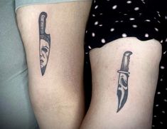 two people with tattoos on their legs holding knives