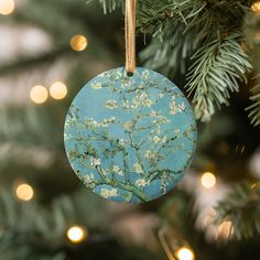 a blue ornament hanging from a christmas tree