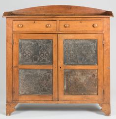 an old wooden cabinet with metal inserts on the doors and drawer drawers, possibly from china