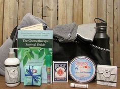 an assortment of personal care items sitting on a table next to a towel and bottle