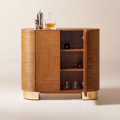 a wooden cabinet with two bottles and glasses on it